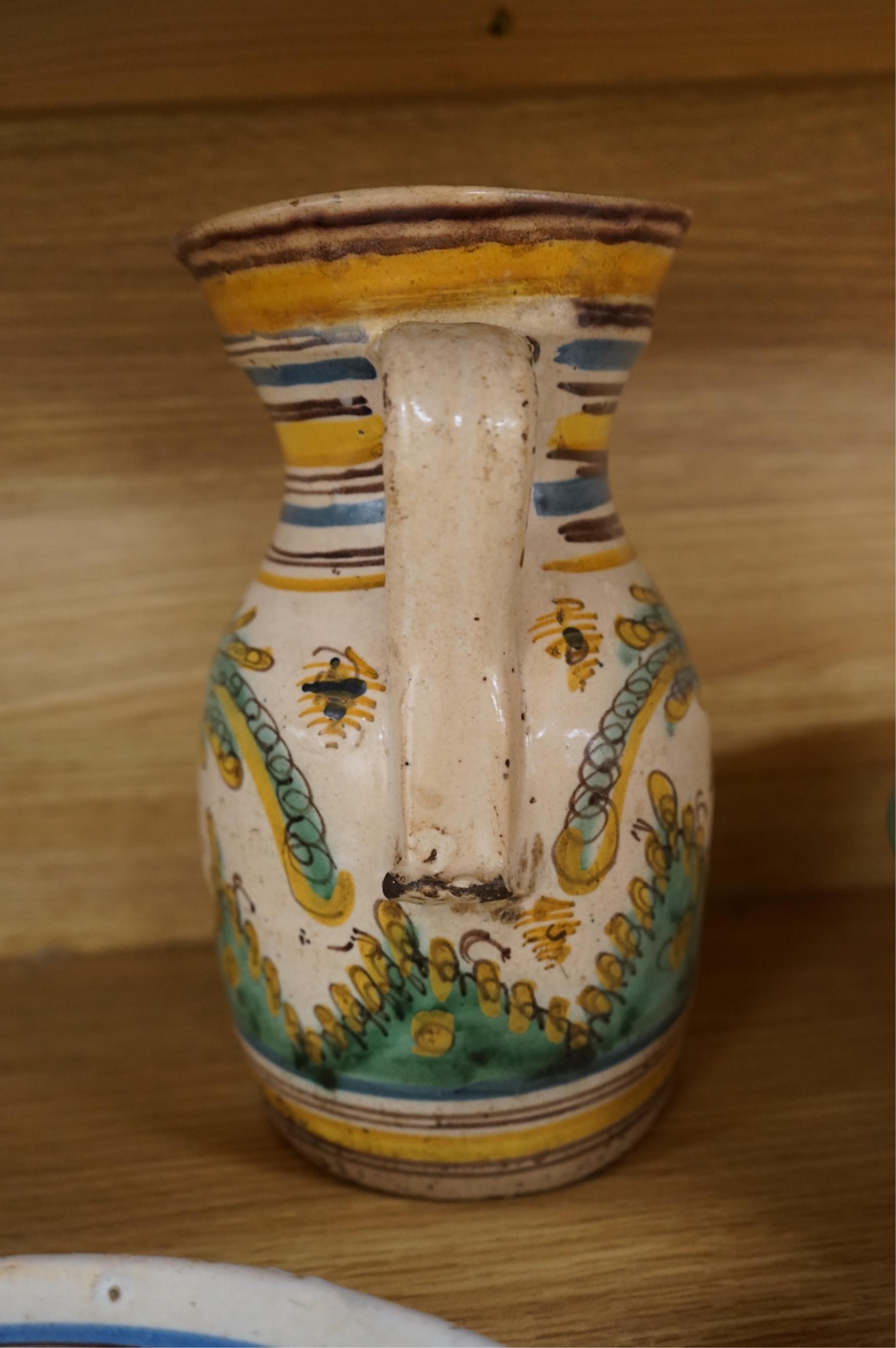 A late 17th century Spanish tin glazed jug together with Moroccan and pottery bowls and dishes (5). Jug 26cm high.